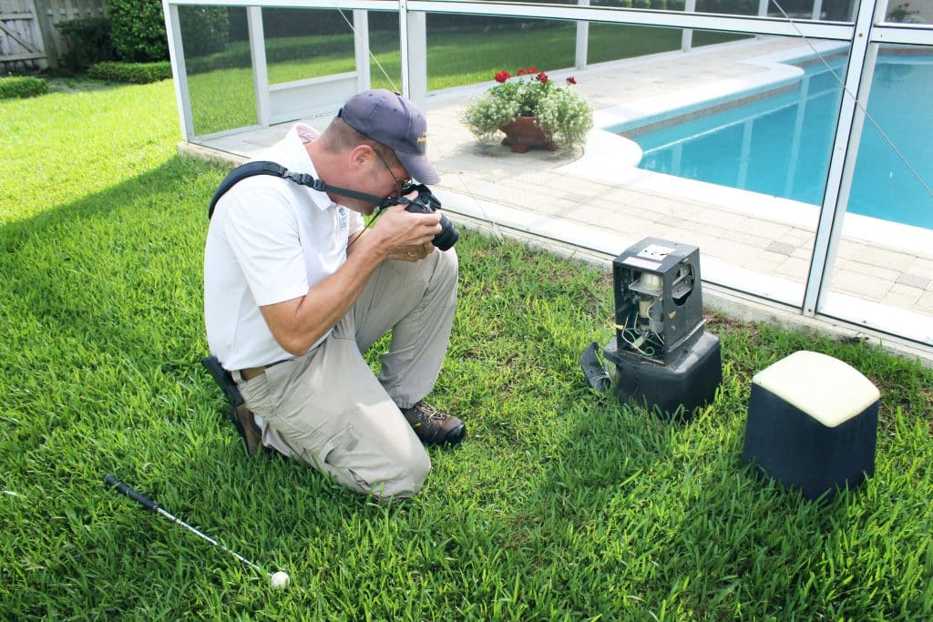 Erik of EDC photographing a pool area outside during a home inspection
