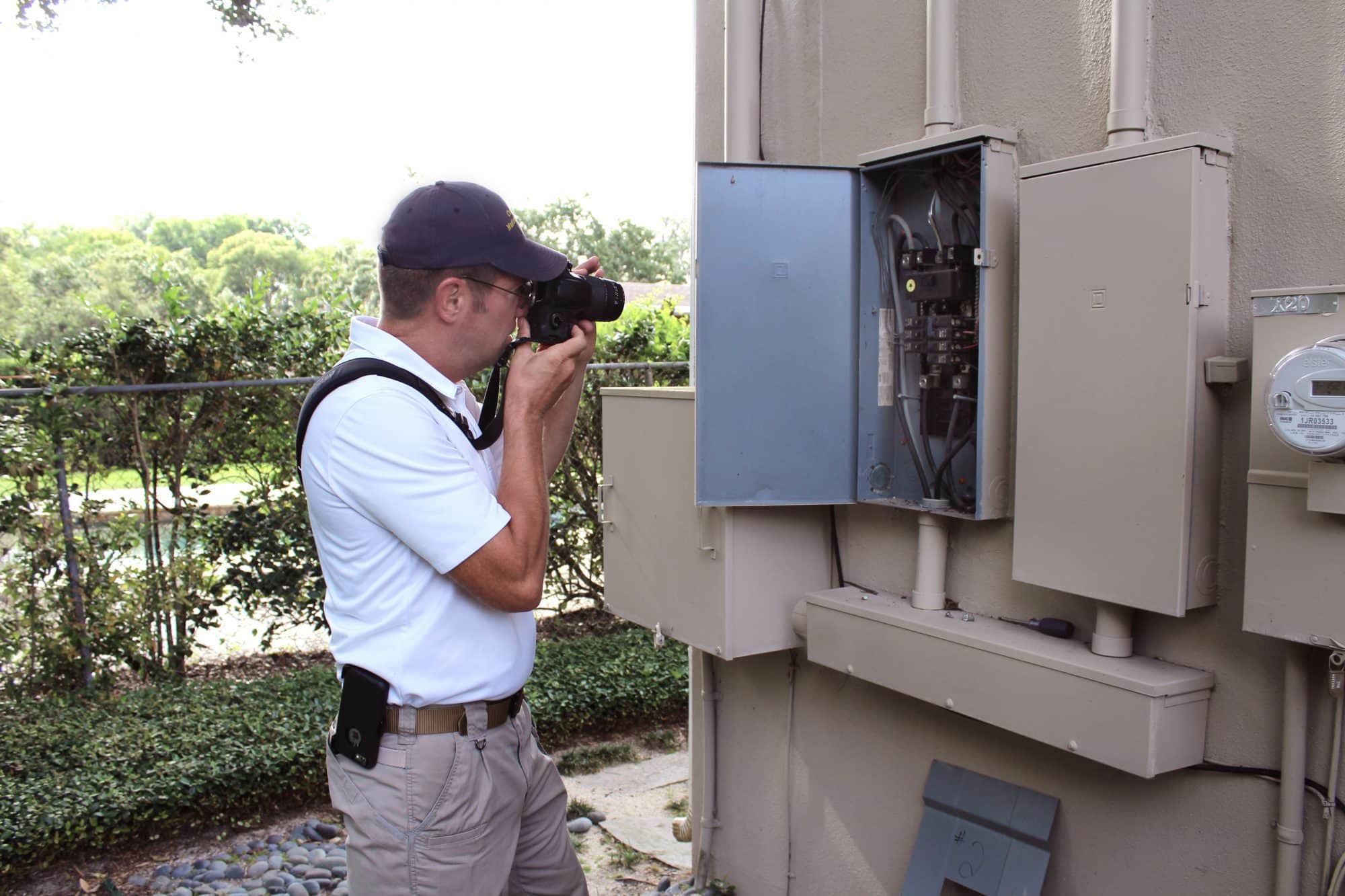 home inspector taking photo of electrical box