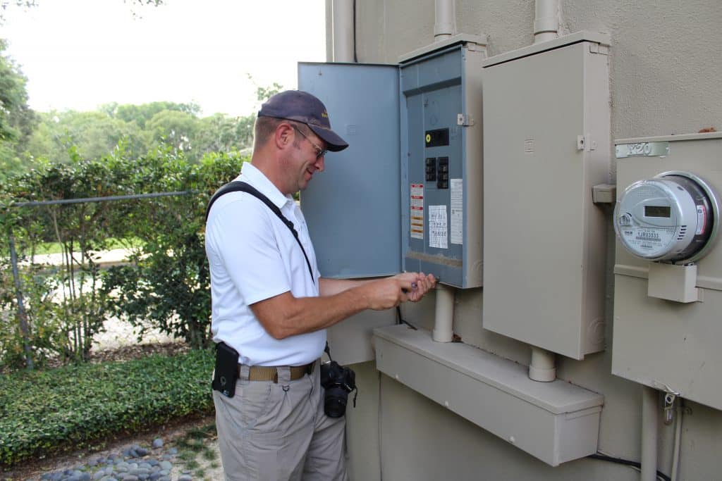 home inspector looking at electrical panel